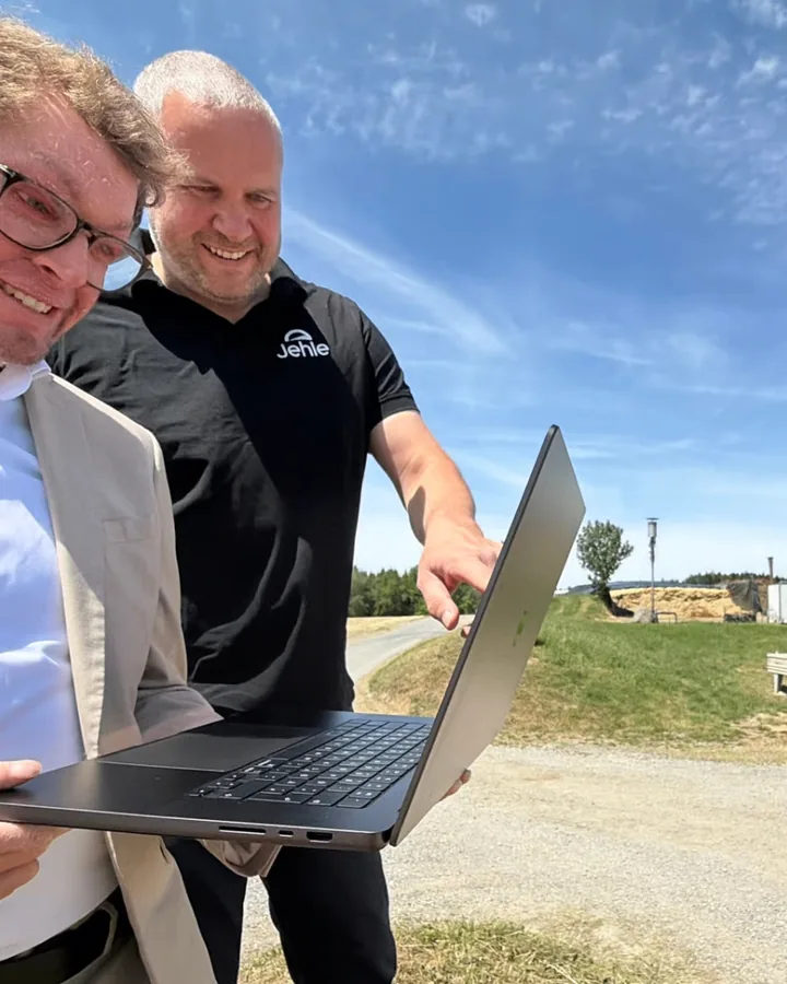 Markus Jehle und Robin Gassmann mit Laptop auf dem Feld